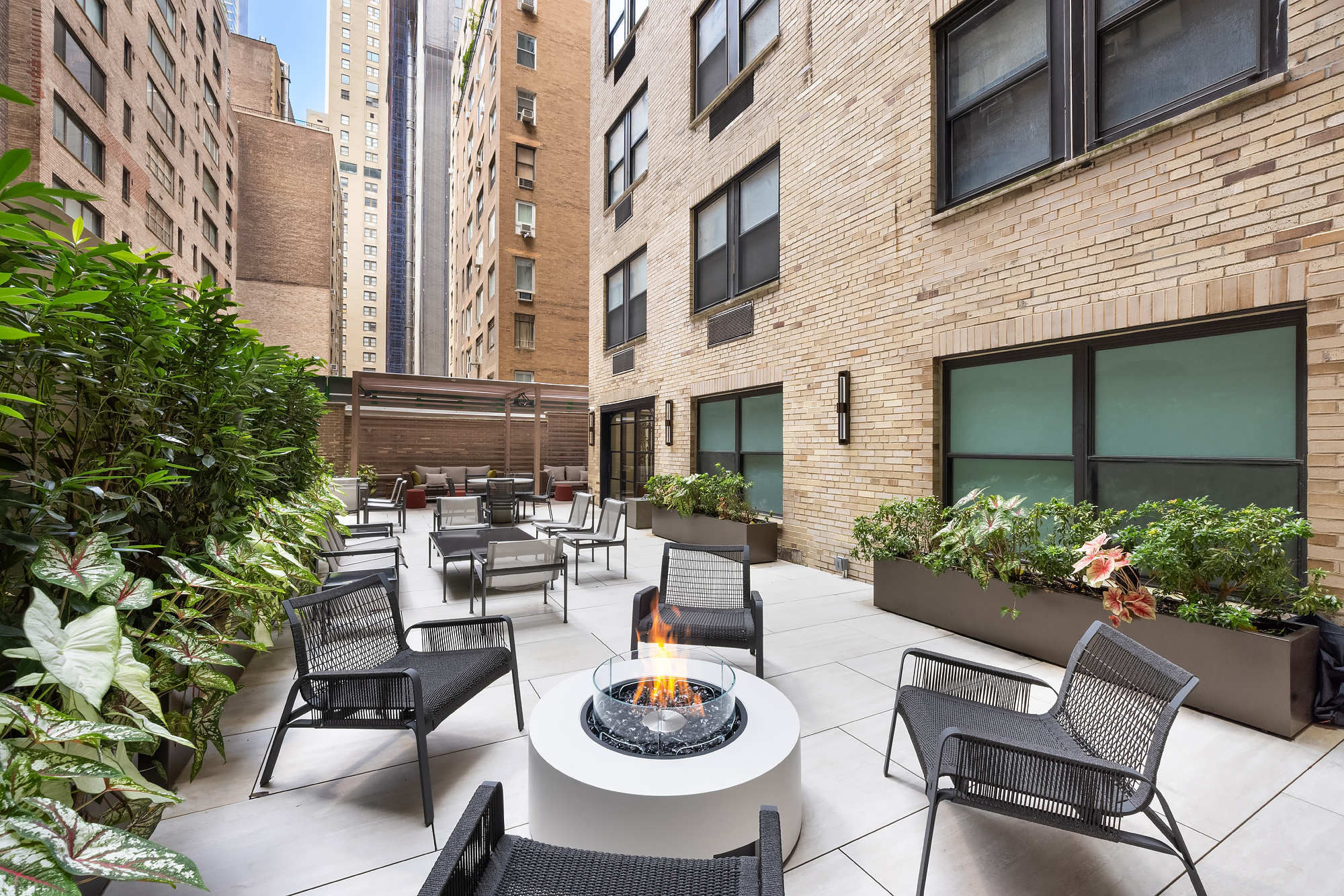 110 Central Park South, Unit 12ABC Manhattan, NY 10019 - Photo 47 of 49 a view of a patio with couches table and chairs and potted plants
