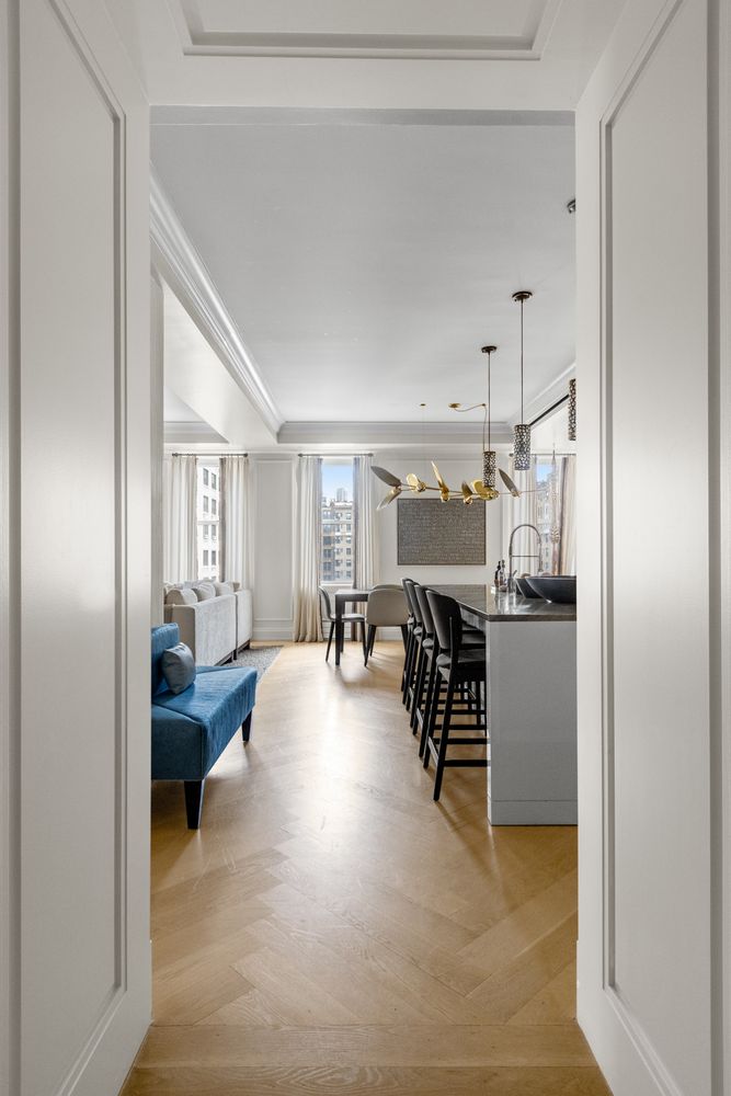 344 West 72nd Street, Unit 1008 Manhattan, NY 10023 - Photo 17 of 35 a living room with furniture and a table