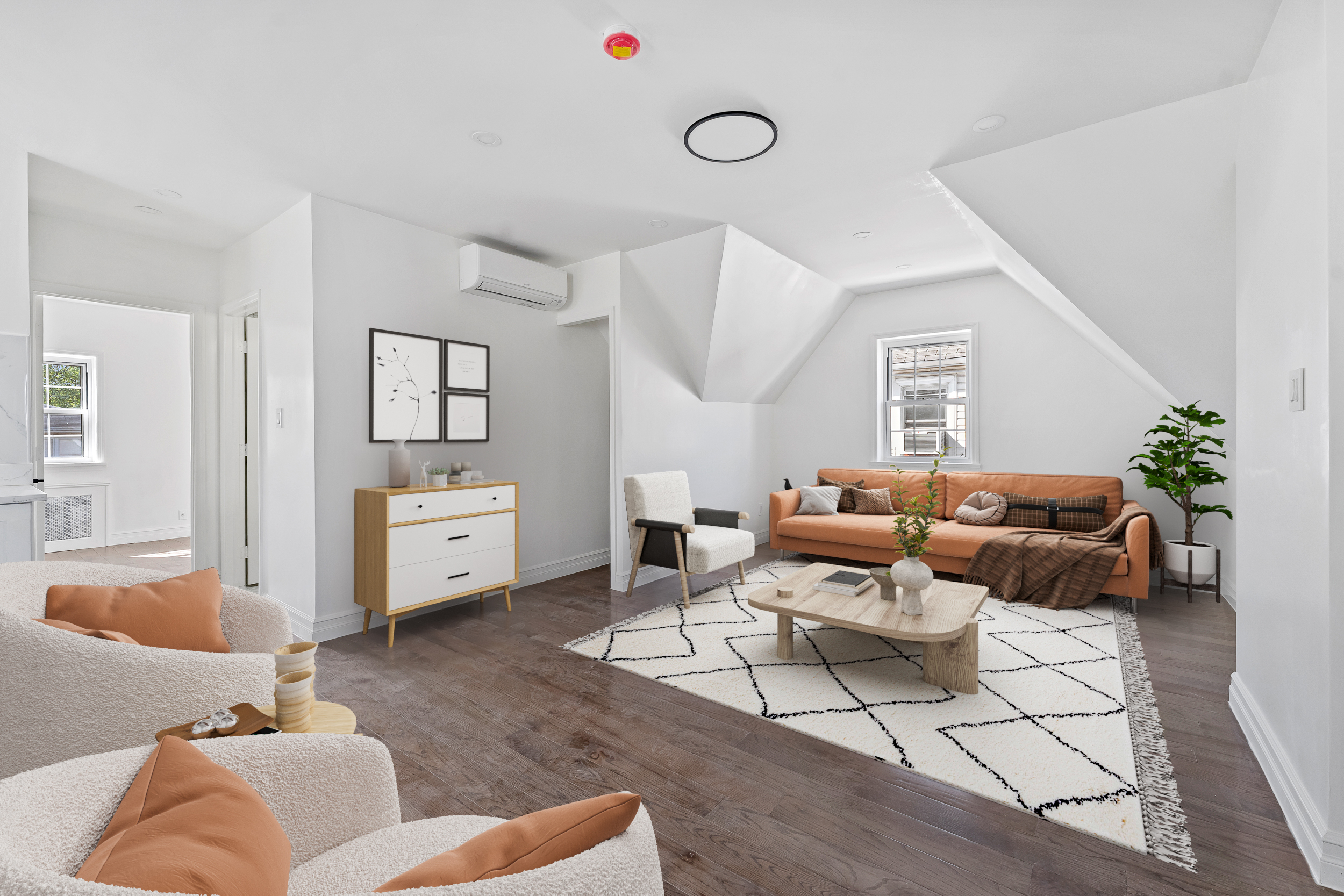 a living room with furniture and wooden floor