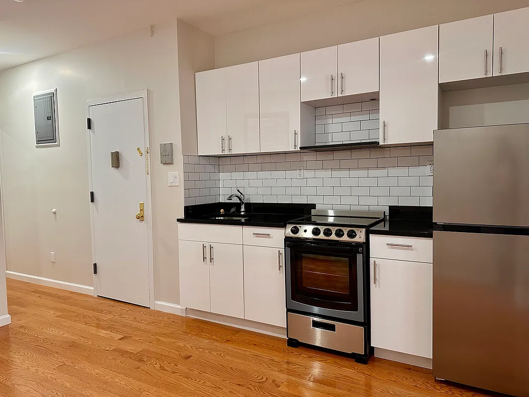 22 St Marks Place, Unit 16 Manhattan, NY 10003 - Photo 4 of 5 a kitchen with a stove and white cabinets