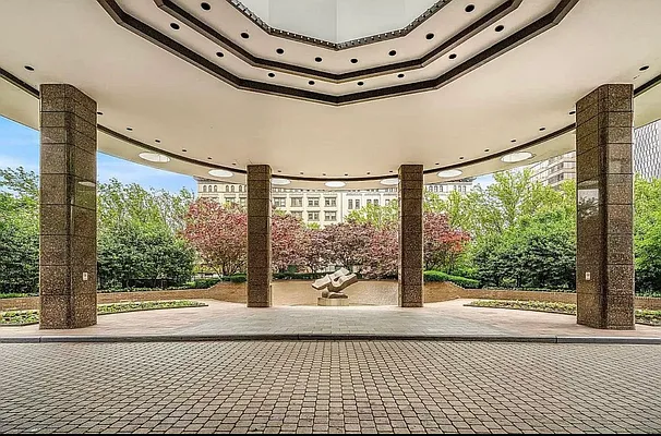 330 East 38th Street, Unit 20E Manhattan, NY 10016 - Photo 11 of 17 a view of an empty room with wooden floor and iron stairs