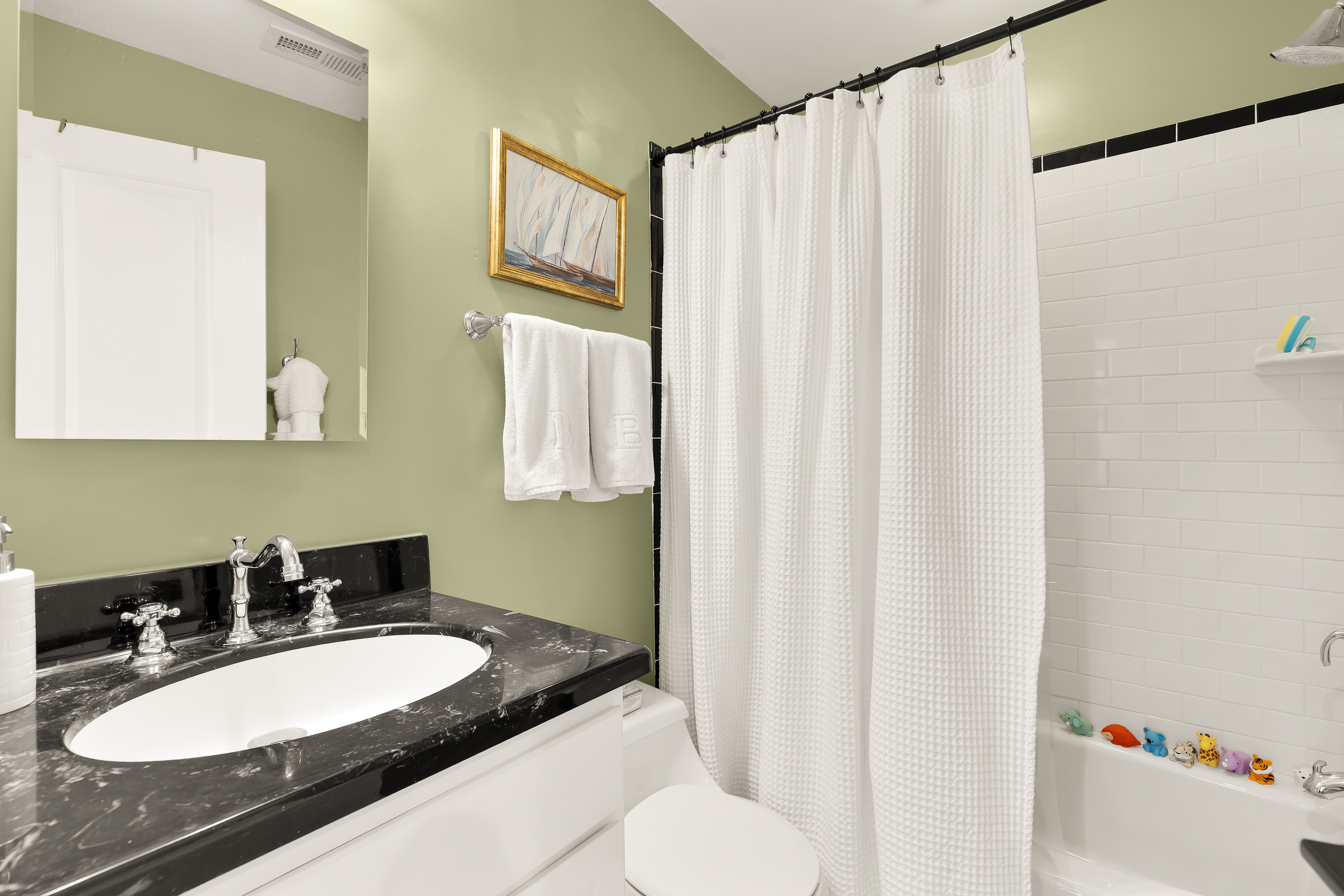 1354 Kenyon Street Northwest, Unit G Washington, DC 20010 - Photo 24 of 35 a bathroom with a sink vanity mirror and a toilet
