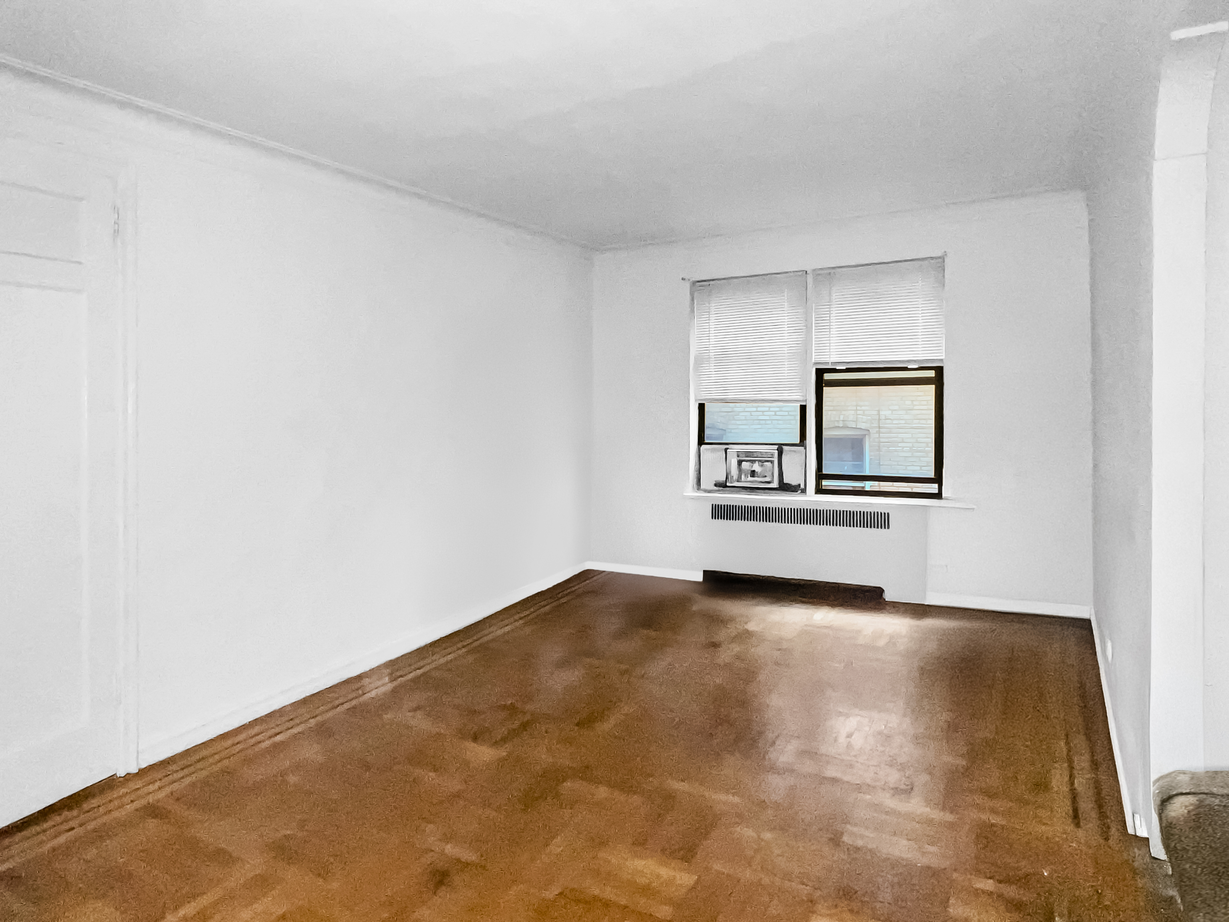 2776 Jerome Avenue, Unit 3C Bronx, NY 10468 - Photo 3 of 8 a view of an empty room with wooden floor and a window