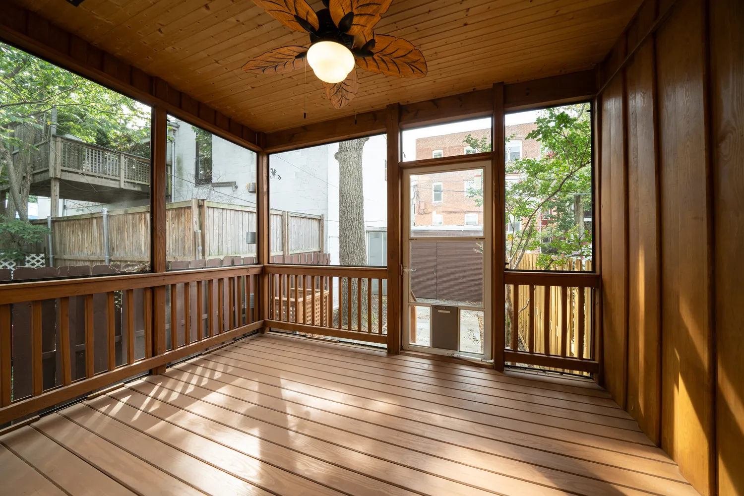 an view of a room that has a large mirror and a wooden floors