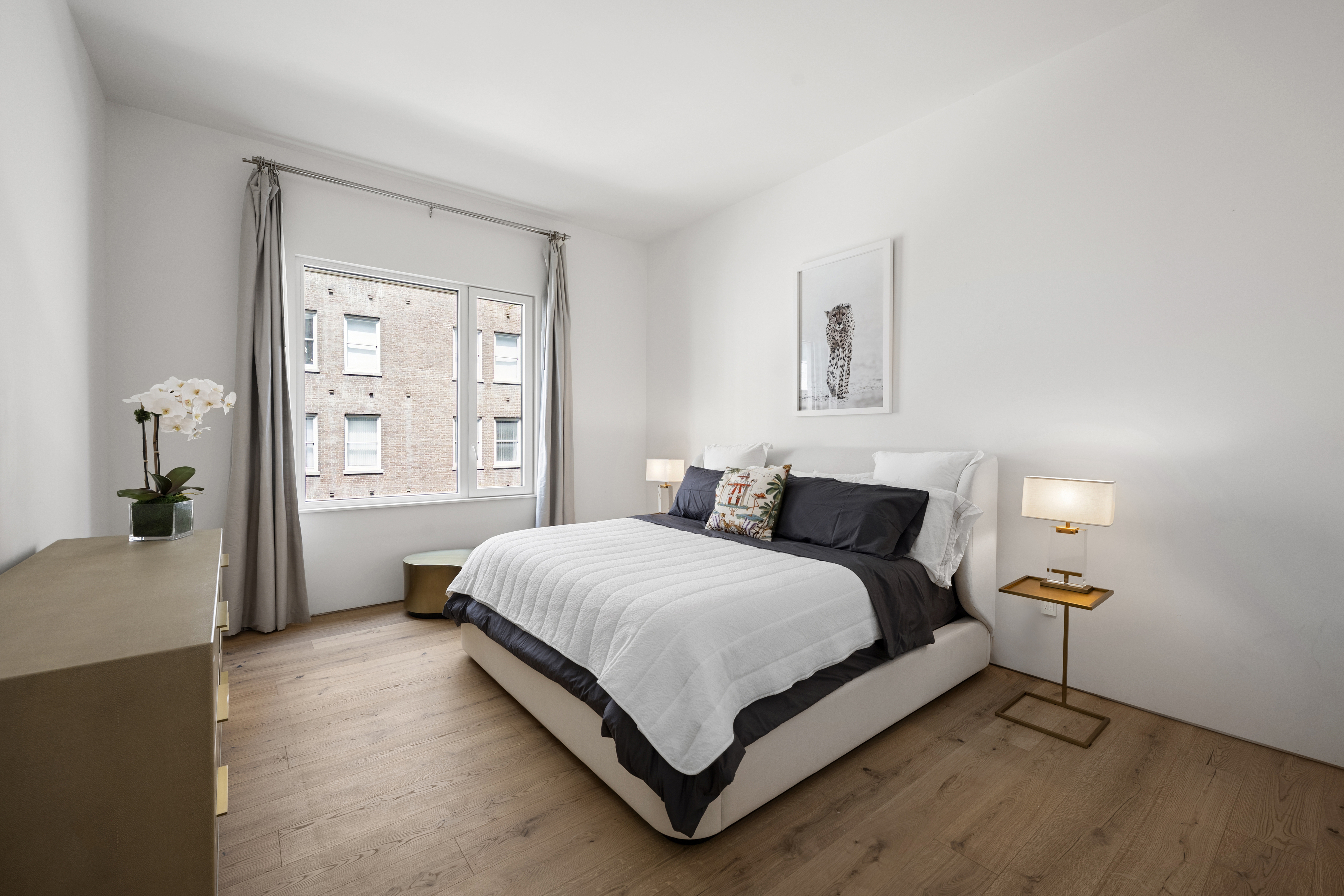 532 West 20th Street, Unit 4 Manhattan, NY 10011 - Photo 9 of 23 a bedroom with a bed lamp and window
