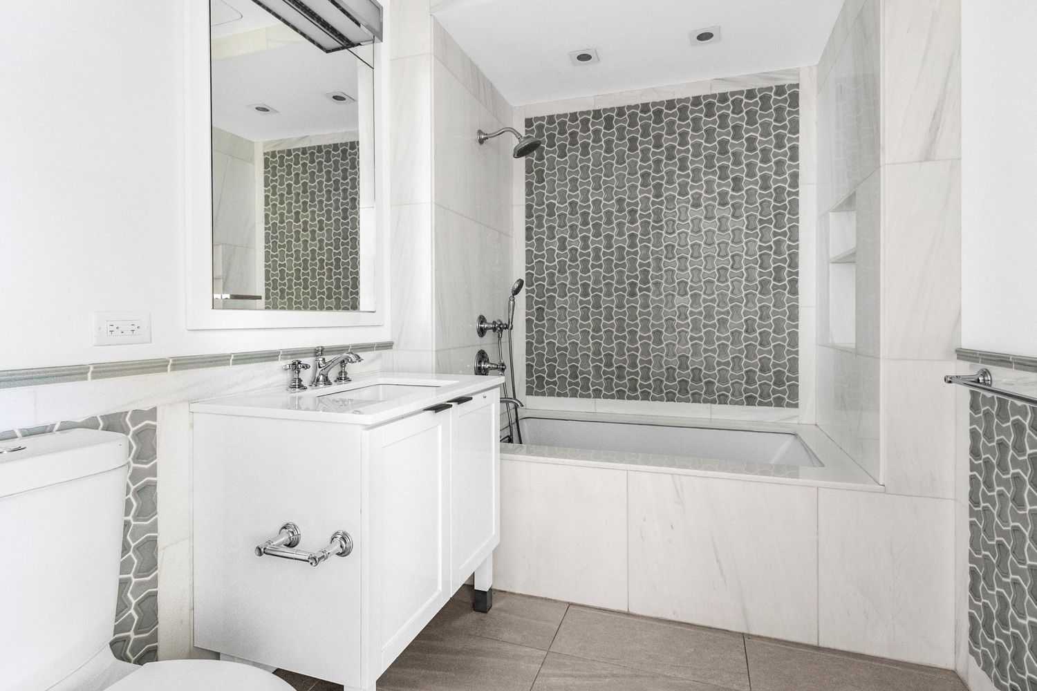344 West 72nd Street, Unit 1008 Manhattan, NY 10023 - Photo 9 of 35 a bathroom with a bathtub sink and mirror