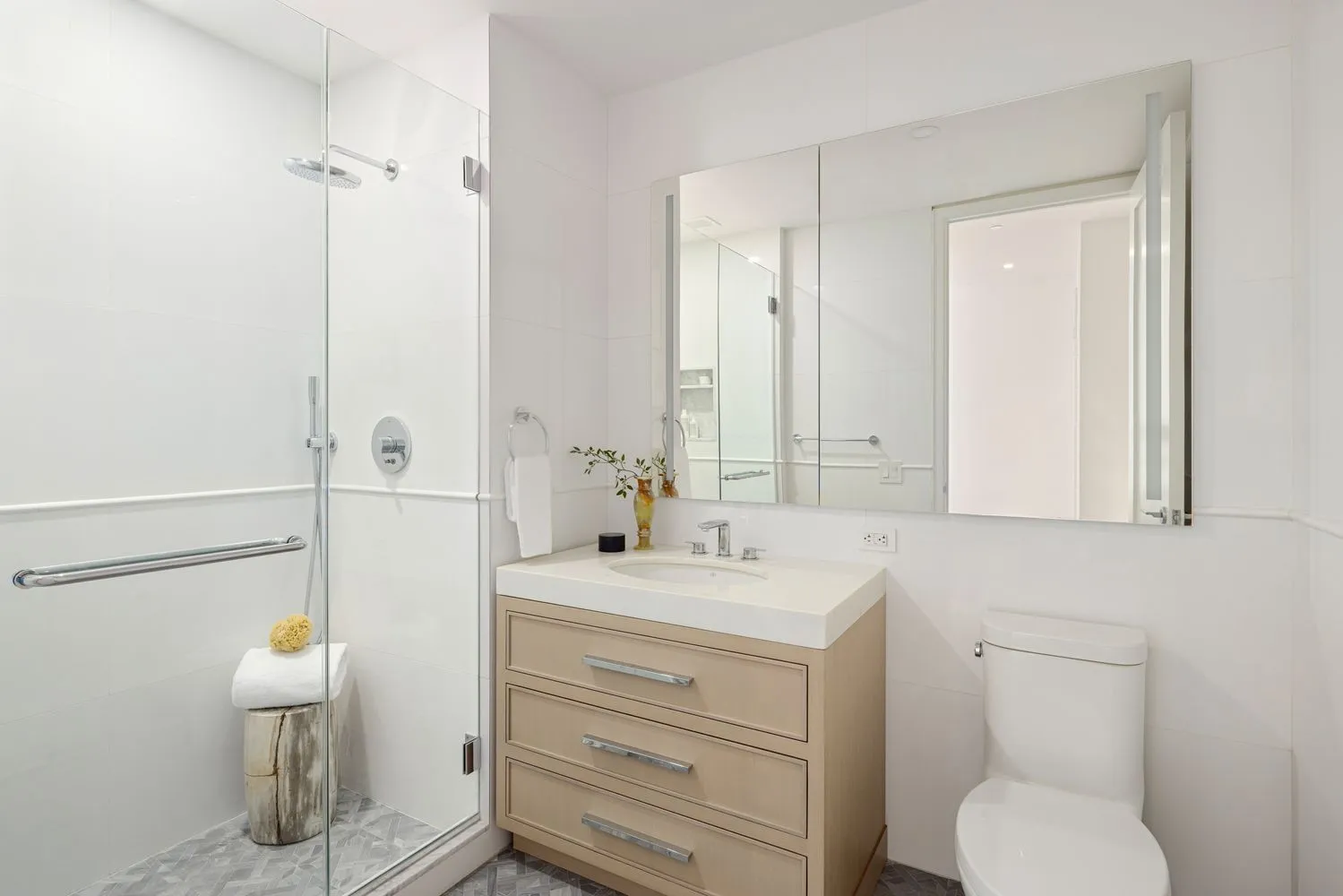 a bathroom with a toilet sink vanity and mirror