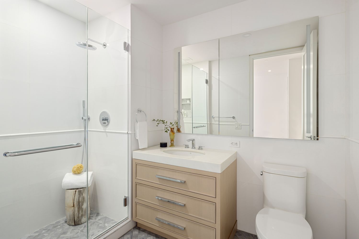 15 West 96th Street, Unit 19 Manhattan, NY 10025 - Photo 10 of 17 a bathroom with a toilet sink vanity and mirror
