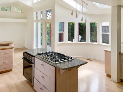 a kitchen view of a kitchen island wooden floor and a window