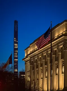 a black and white building with trees in front of it
