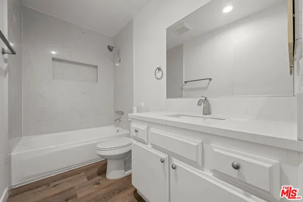 a bathroom with a sink a toilet and a bathtub