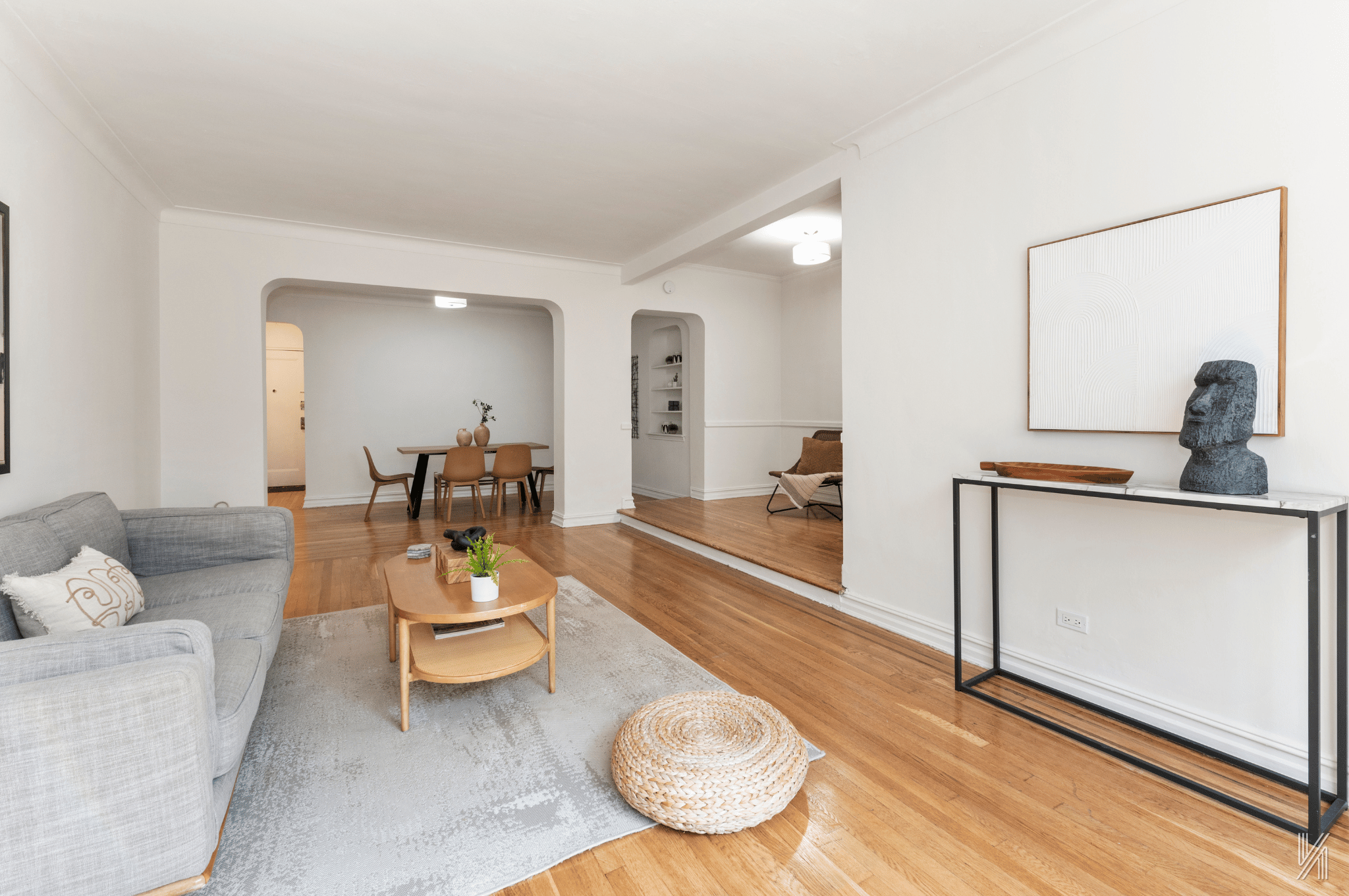 a living room with furniture and a wooden floor