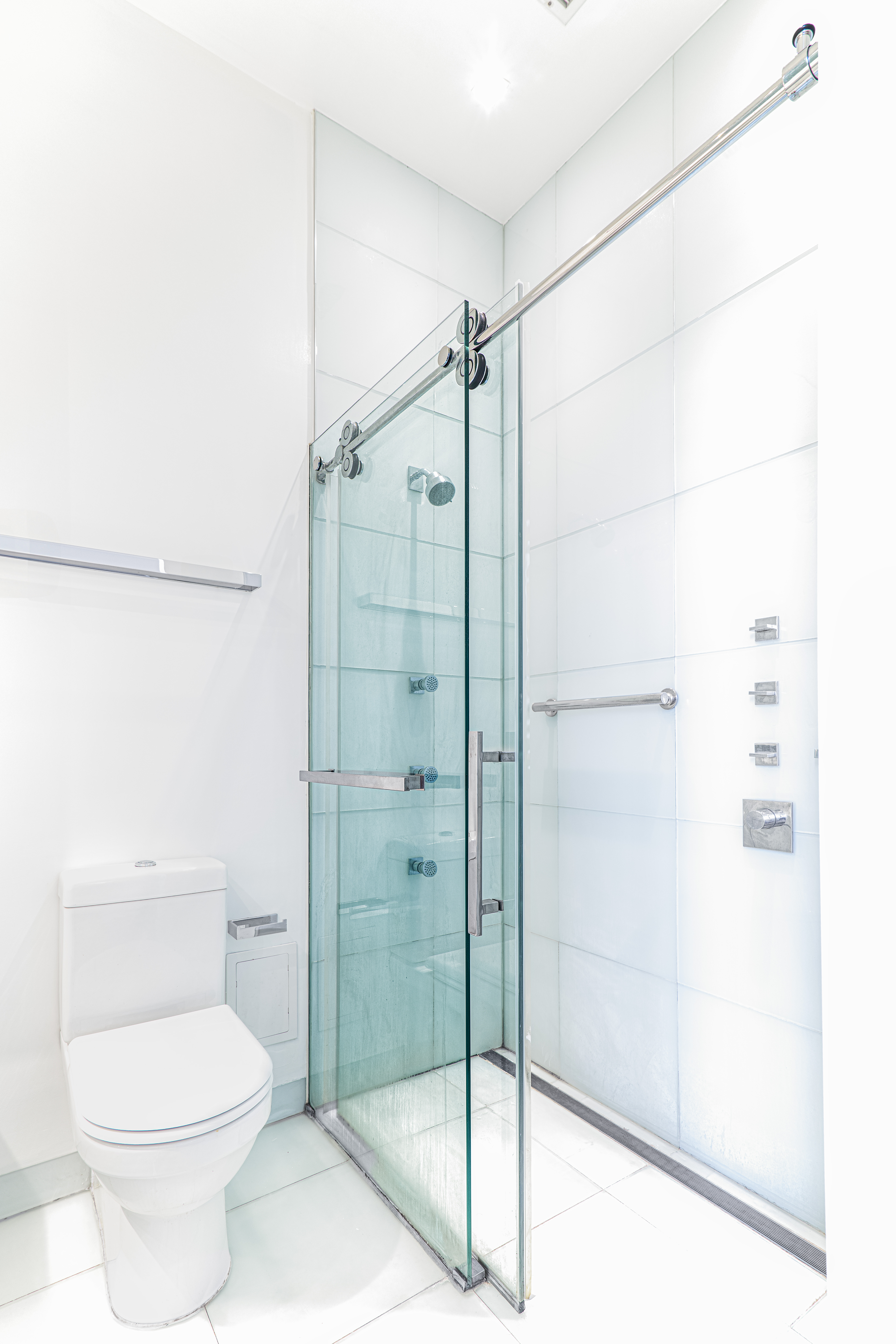 303 Mercer Street, Unit A601 Manhattan, NY 10003 - Photo 16 of 19 a bathroom with a shower and a toilet