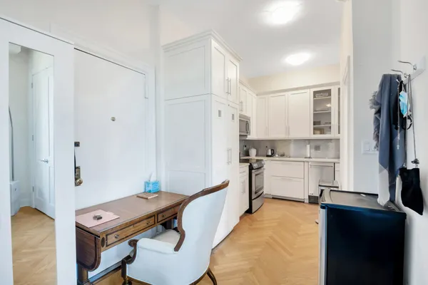 a kitchen with granite countertop white cabinets stainless steel appliances and a sink