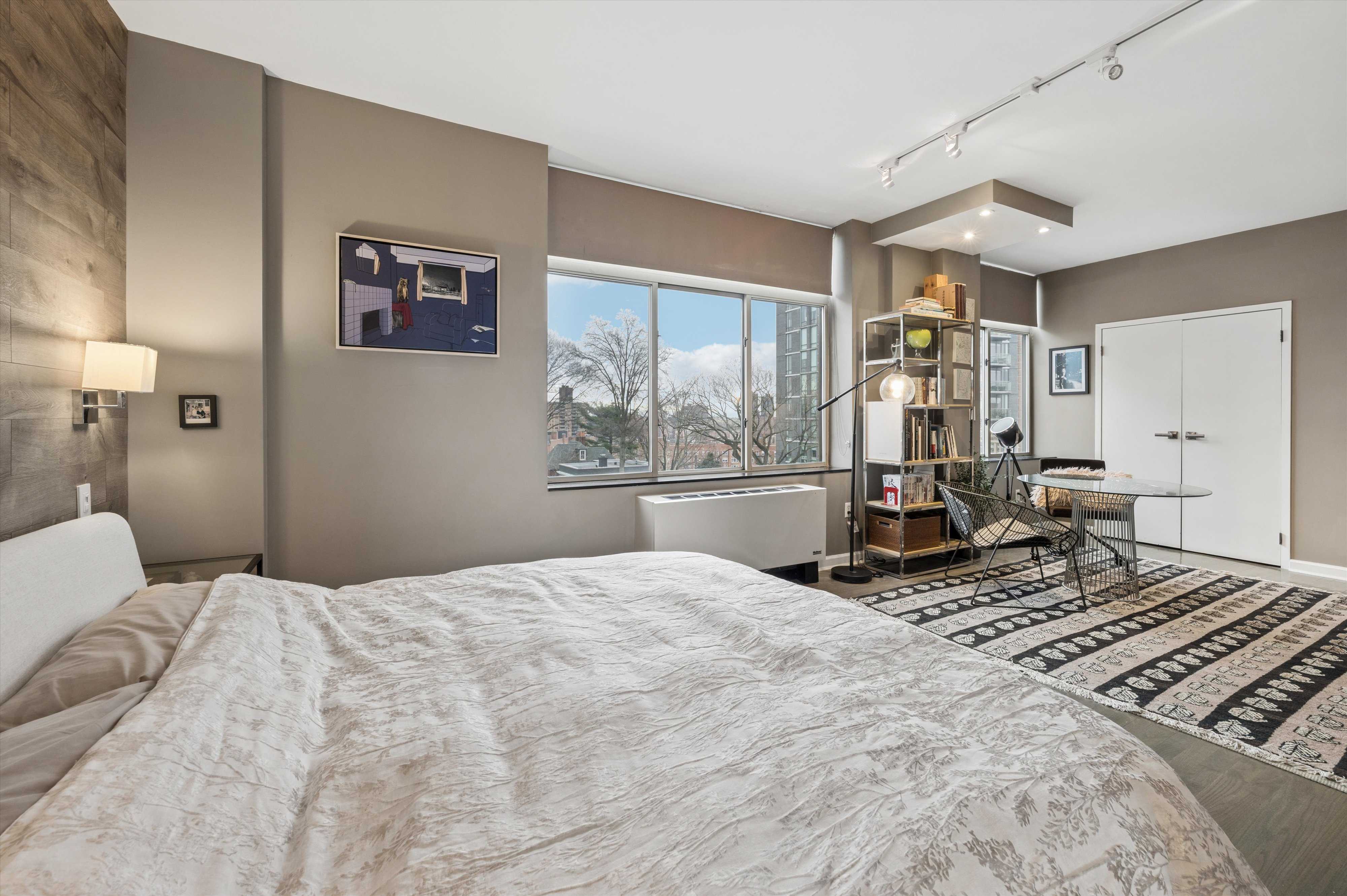 3625 Oxford Avenue, Unit 7C Bronx, NY 10463 - Photo 11 of 20 a bedroom with a bed large window and wall painting