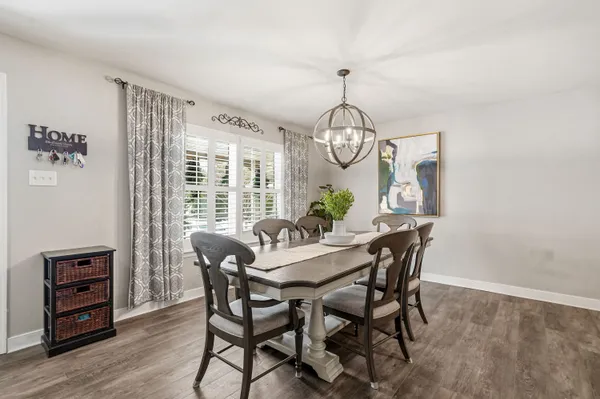 a view of a dining room with furniture wooden floor and chandelier