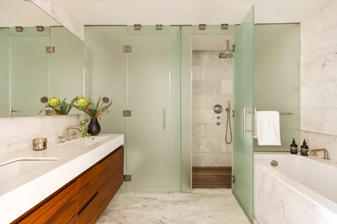 a bathroom with a tub sink and mirror