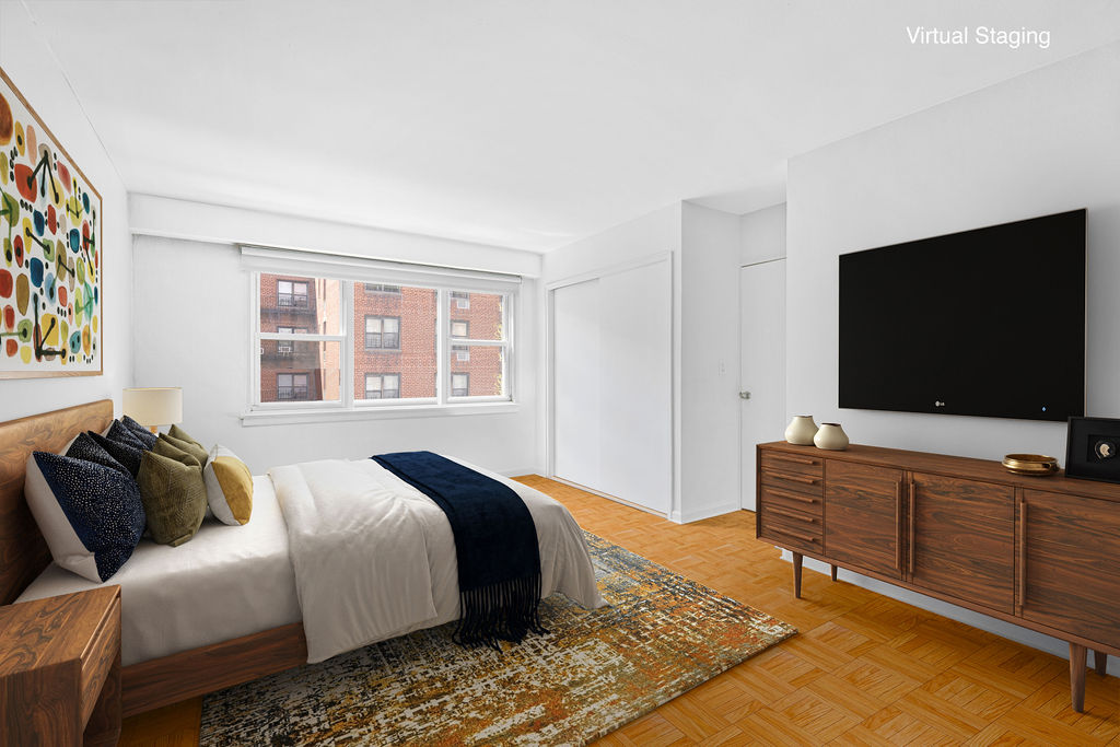 101 West 12th Street, Unit 5V Manhattan, NY 10011 - Photo 4 of 26 a bedroom with a bed and television