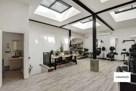 a living room with lots of furniture and gym equipment