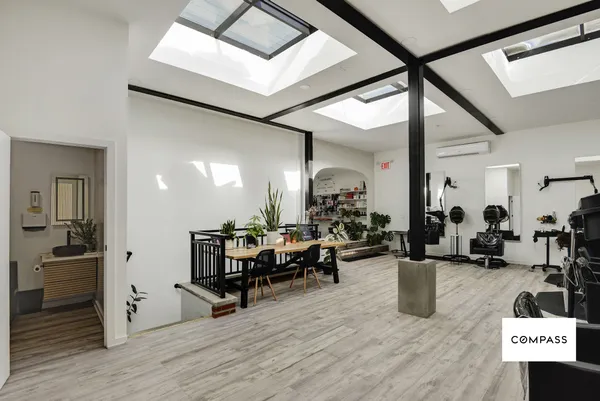 a living room with lots of furniture and gym equipment