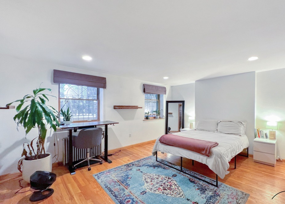 75 Warren Street, Unit 1 Brooklyn, NY 11201 - Photo 5 of 14 a bedroom with a bed a table and chair