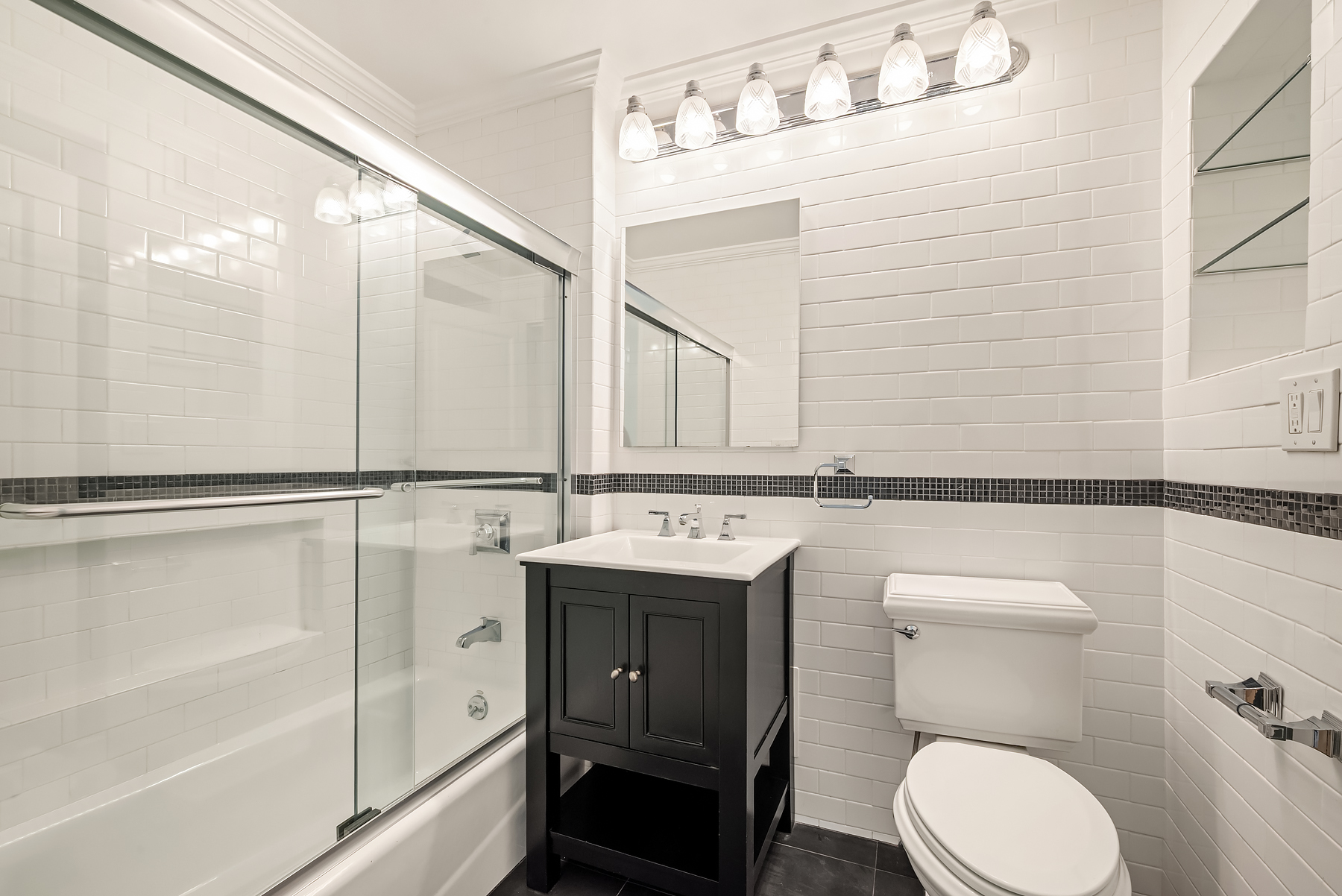 404 East 76th Street, Unit 7C Manhattan, NY 10021 - Photo 8 of 13 a bathroom with a sink toilet and shower