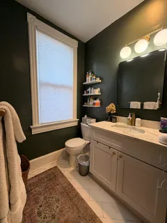a bathroom with a toilet sink and mirror