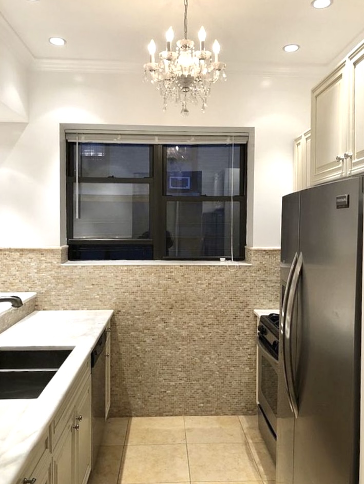 1240 Park Avenue, Unit 6B Manhattan, NY 10128 - Photo 5 of 13 a kitchen with a sink and refrigerator