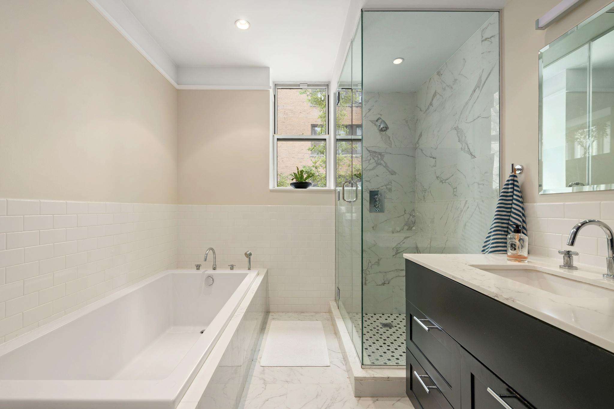 309 West 103rd Street, Unit 3 Manhattan, NY 10025 - Photo 6 of 9 a bathroom with a bathtub sink a toilet and a mirror