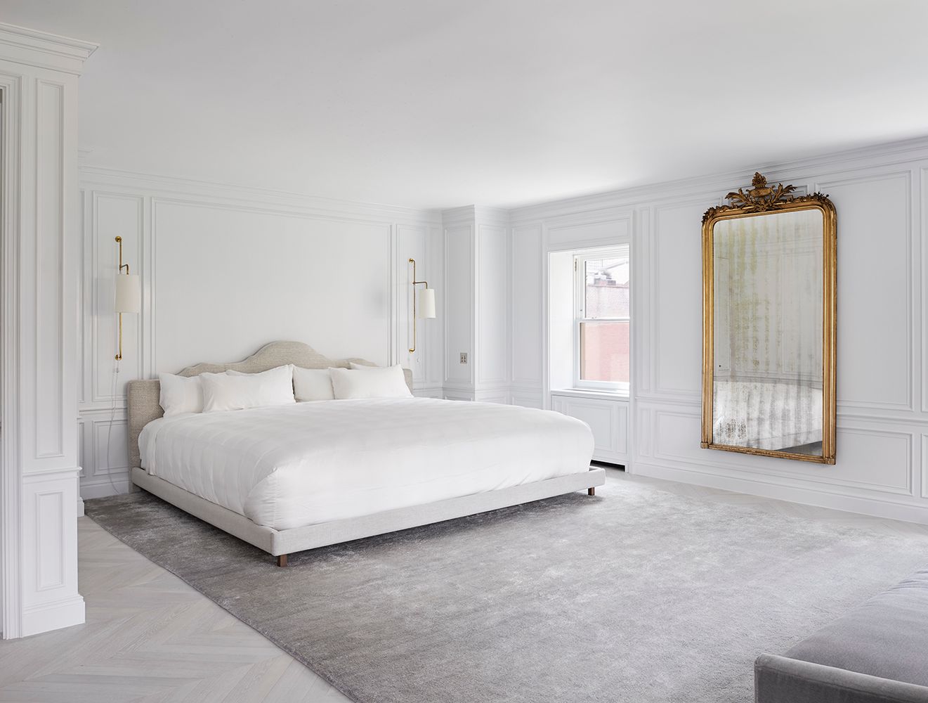 a large white bed in a white room