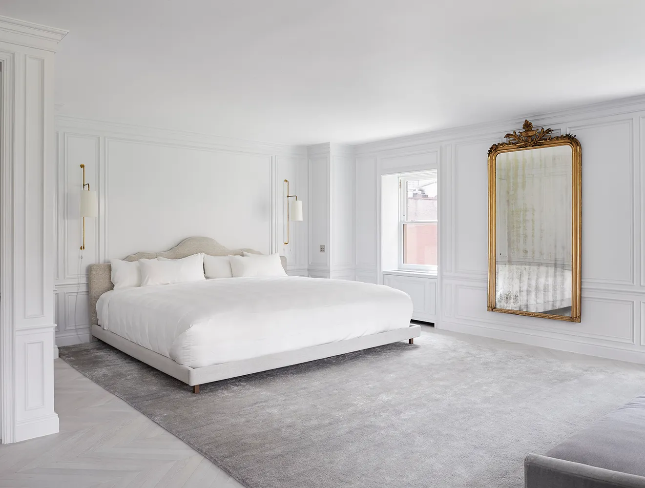 a large white bed in a white room