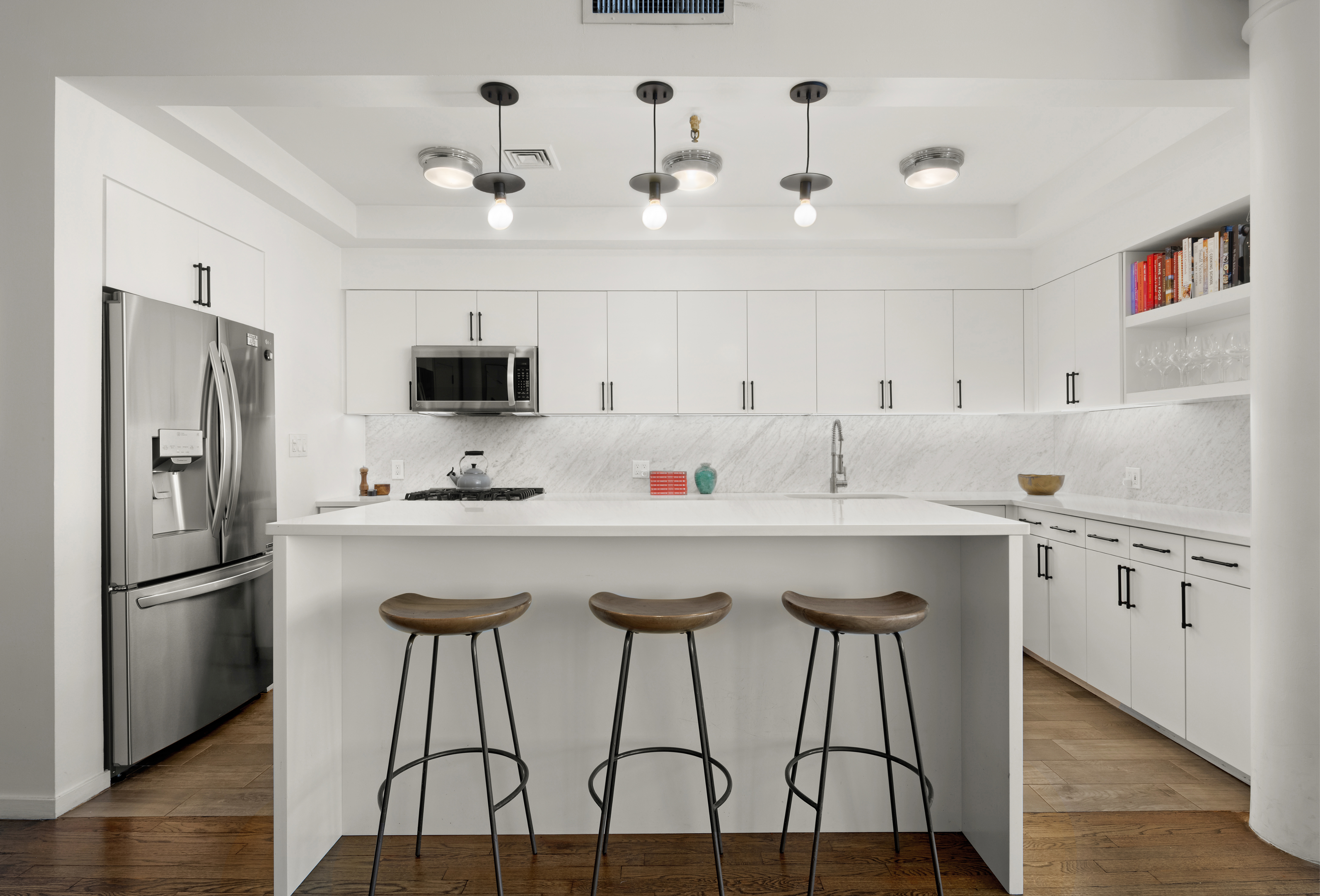 120 West 18th Street, Unit 2A Manhattan, NY 10011 - Photo 5 of 14 a kitchen with stainless steel appliances granite countertop a sink and a refrigerator
