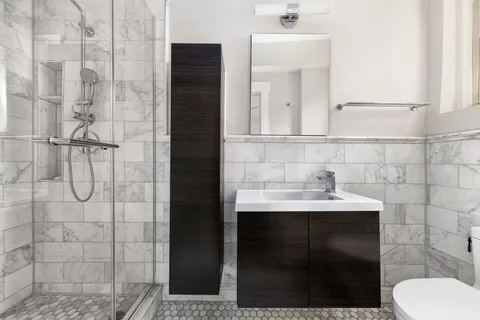 a bathroom with a sink toilet and shower