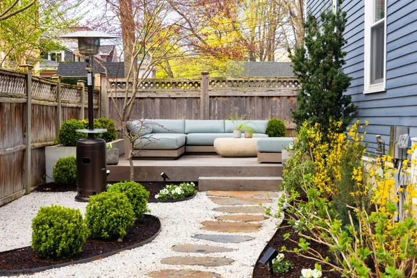 a view of a patio with couches table and chairs and potted plants