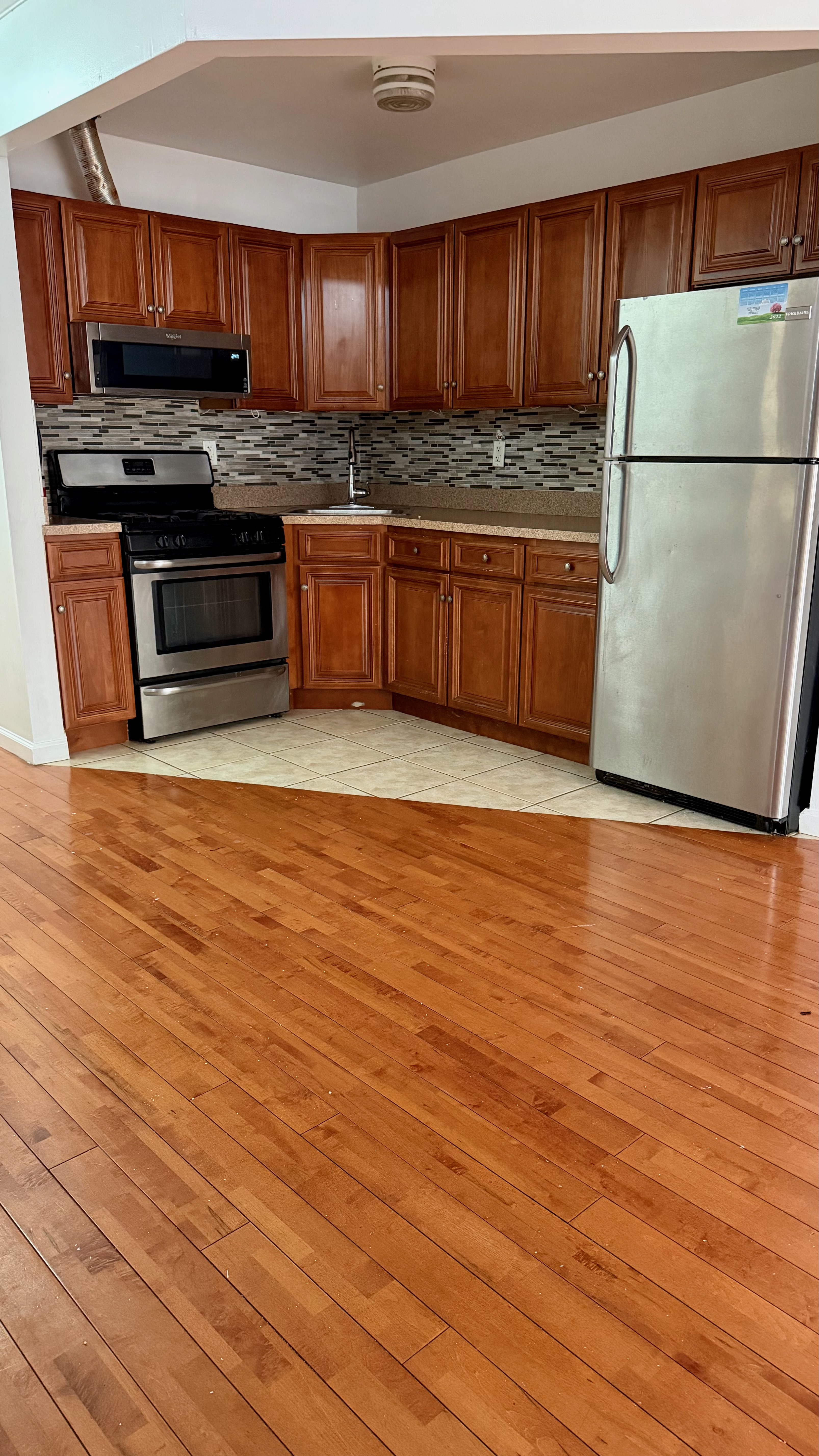 48 Schenck Avenue, Unit 3 Brooklyn, NY 11207 - Photo 1 of 7 a view of kitchen with stainless steel appliances granite countertop a stove a refrigerator and a microwave oven