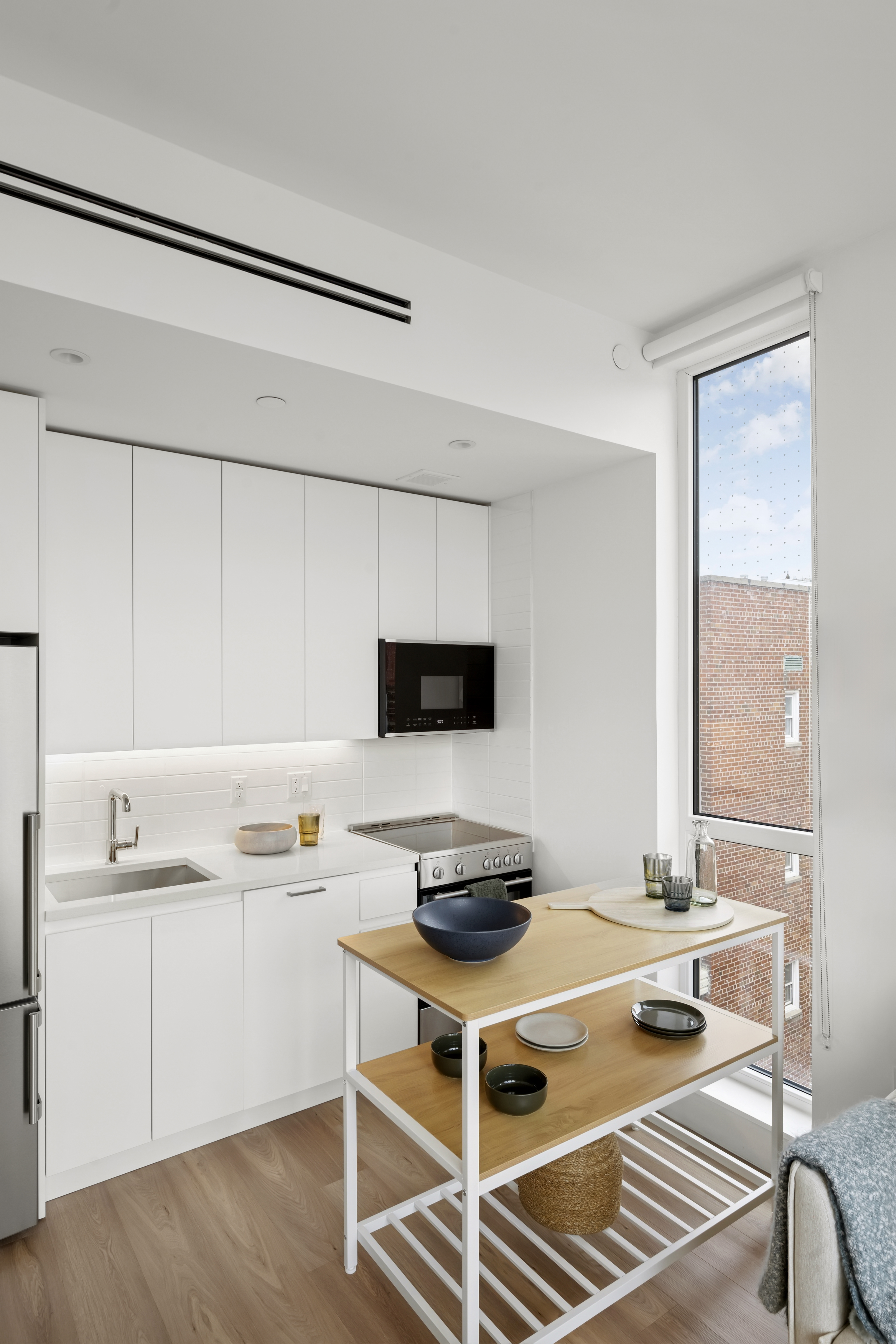 340 Lenox Road, Unit 6D Brooklyn, NY 11226 - Photo 5 of 29 a kitchen with a stove and a white refrigerator