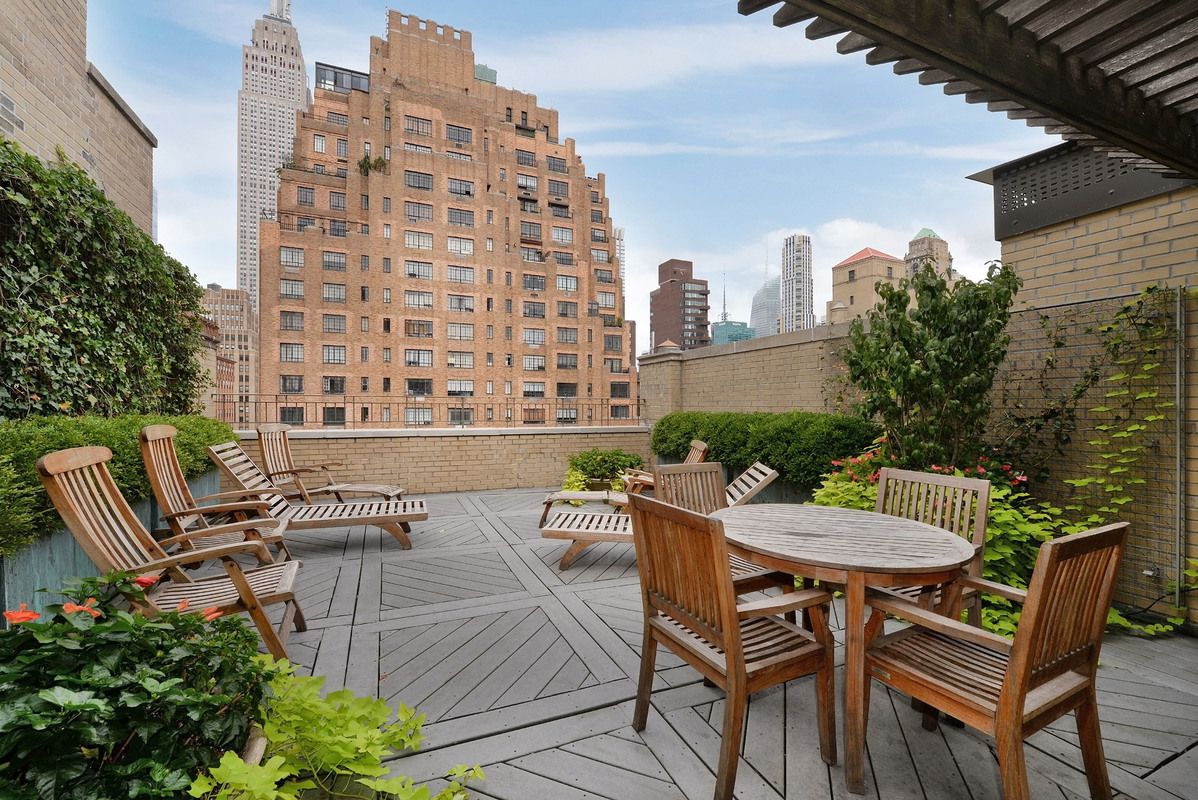 7 Park Avenue, Unit 7J Manhattan, NY 10016 - Photo 7 of 8 a view of a patio with a table and chairs and potted plants