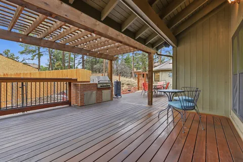 a dining room with wooden floor and outdoor space