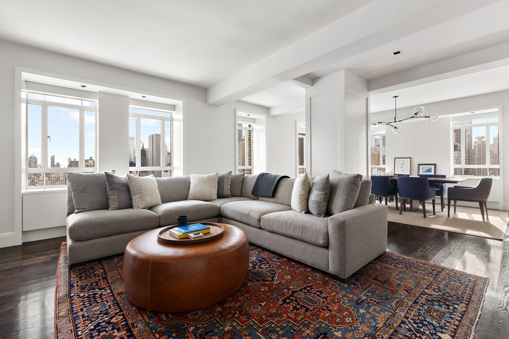 25 Central Park West, Unit 27J Manhattan, NY 10023 - Photo 1 of 13 a living room with furniture a wooden floor and a large window