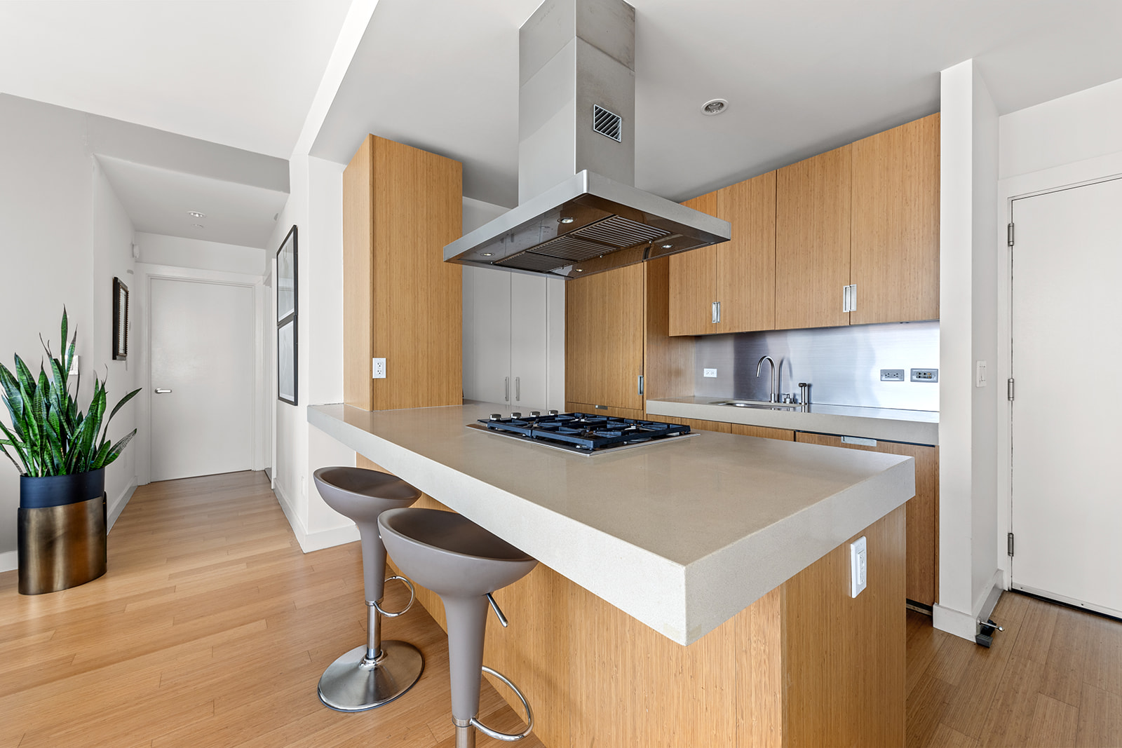 450 West 17th Street, Unit 2208 Manhattan, NY 10011 - Photo 7 of 8 a kitchen with a stove a table and chairs in it