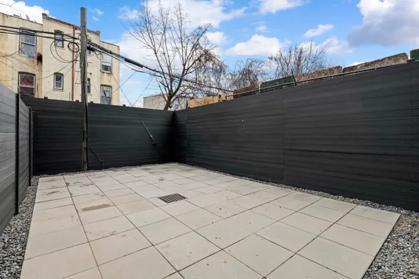 a view of a parking space with wooden fence