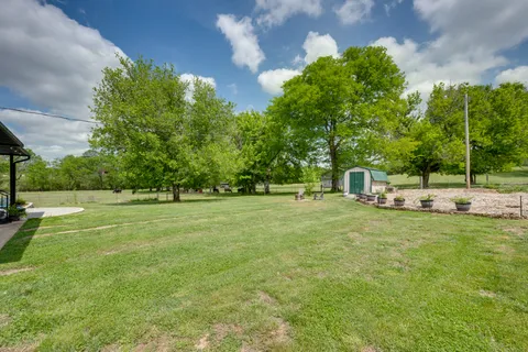 a view of green field with trees