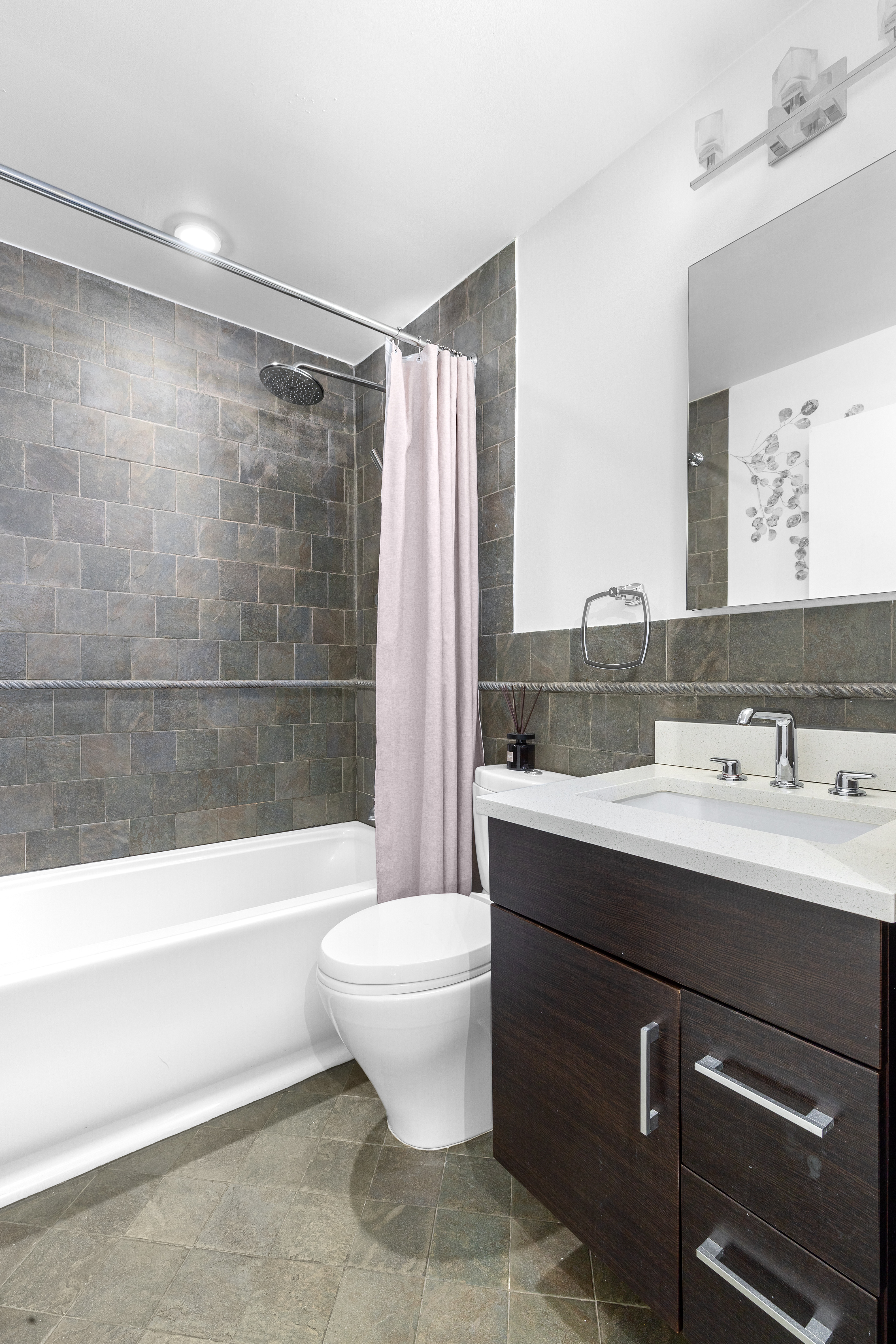 372 5th Avenue, Unit 5F Manhattan, NY 10018 - Photo 6 of 9 a bathroom with a sink a toilet and shower