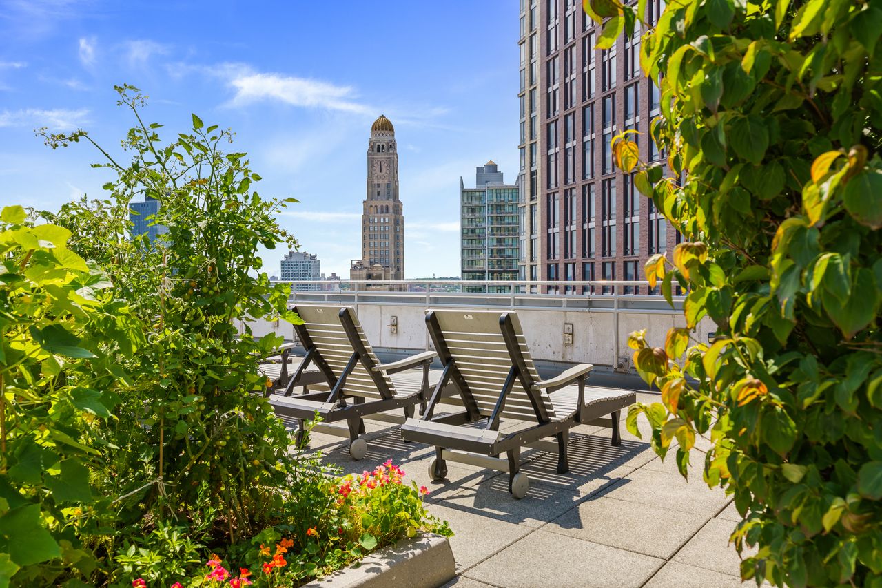 230 Ashland Place, Unit 26A Brooklyn, NY 11217 - Photo 11 of 12 a view of a patio with table and chairs and potted plants