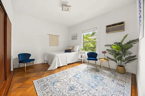 a bedroom with a bed and a chair