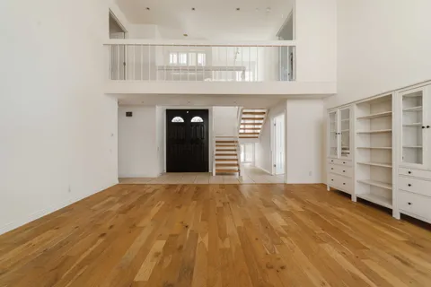 a view of an empty room with a cabinet