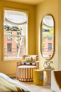 a living room with couch chairs and a window