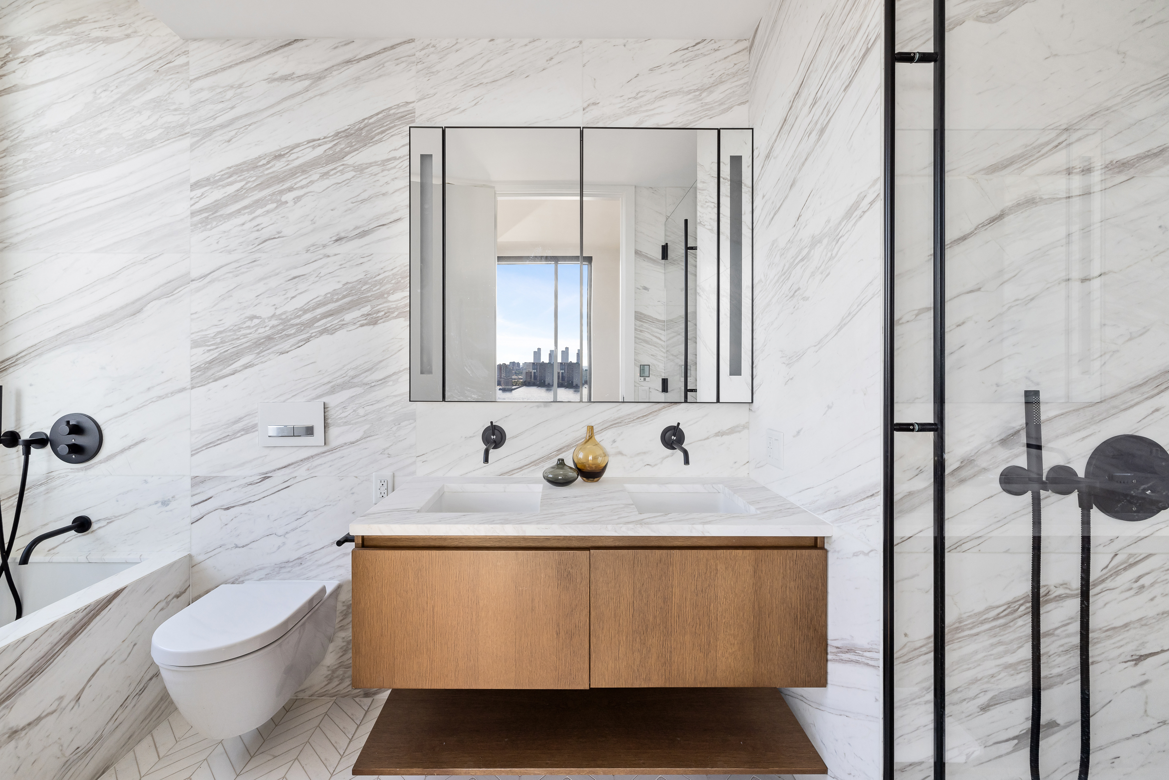 570 Broome Street, Unit 23A Manhattan, NY 10013 - Photo 8 of 13 a bathroom with a granite countertop sink and a mirror