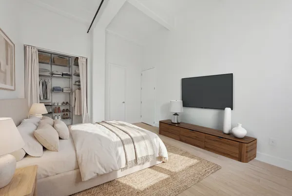 a bedroom with a bed and a flat screen tv