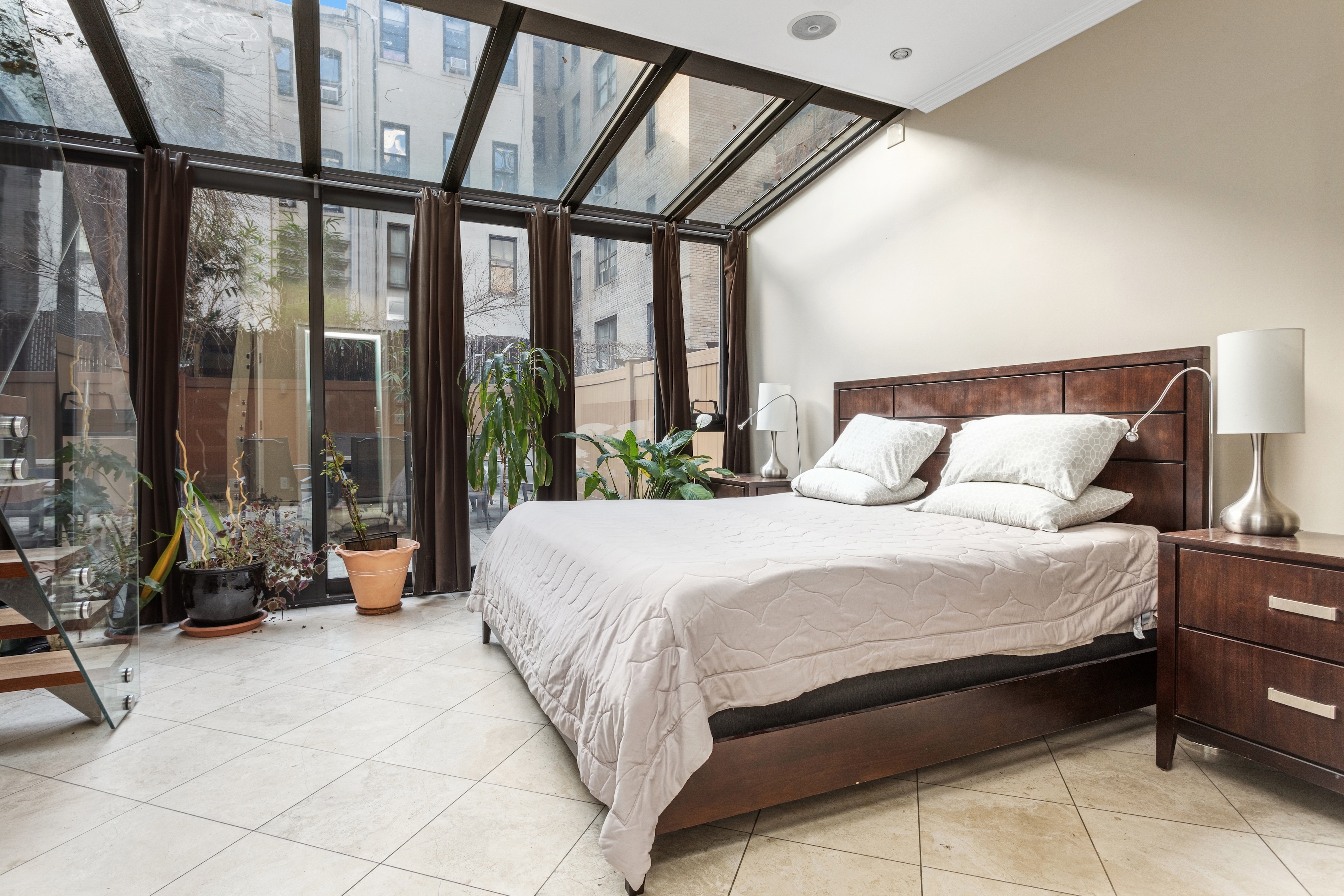 258 West 71st Street, Unit BR Manhattan, NY 10023 - Photo 4 of 13 a bedroom with a bed and a large window